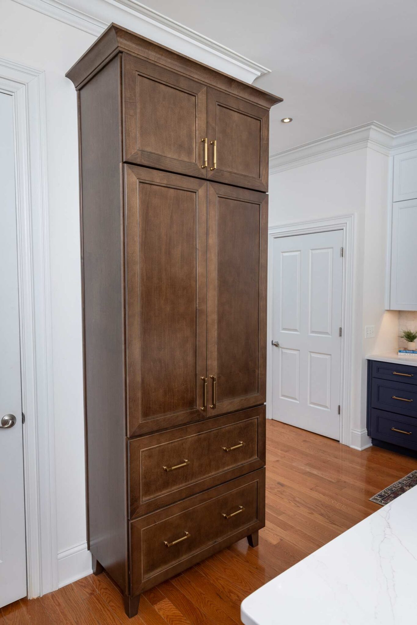 Saddle stained pantry cabinet by KraftMaid